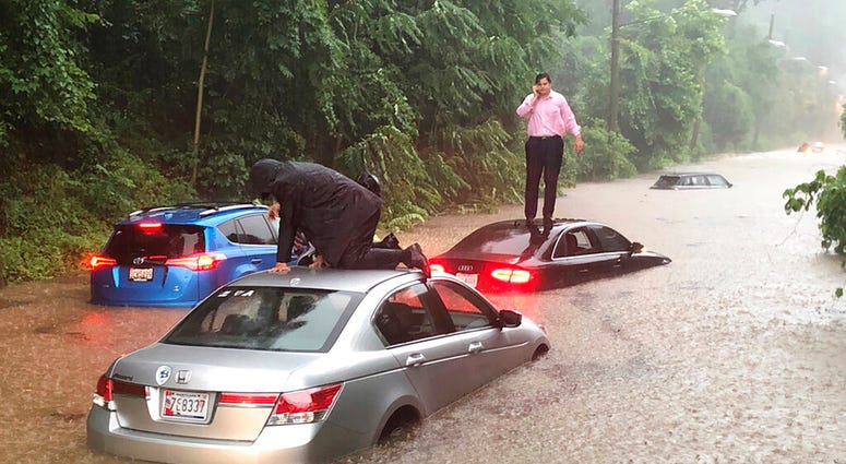 Motorists are stranded on a flooded section of Canal Road in Washington during a heavy rainstorm, Monday, July 8, 2019. (Dave Dildine/WTOP via AP)