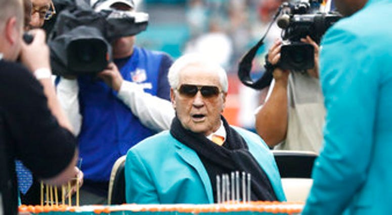FILE - Former Miami Dolphins head coach Don Shula looks at a large cake celebrating the 1972 undefeated season and his birthday during half time at an NFL football game against the Cincinnati Bengals. (AP Photo/Brynn Anderson, File) FILE - Former Miami Dolphins head coach Don Shula looks at a large cake celebrating the 1972 undefeated season and his birthday during half time at an NFL football game against the Cincinnati Bengals. (AP Photo/Brynn Anderson, File)