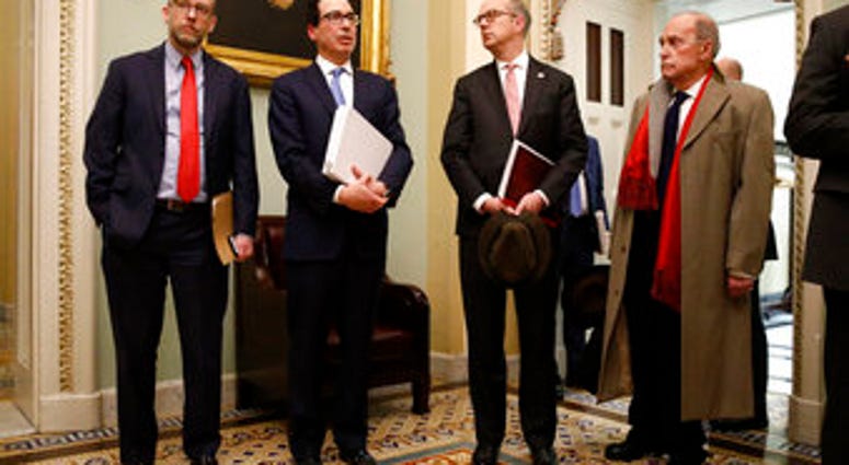 Treasury Secretary Steve Mnuchin, second from left, speaks with members of the media as he departs a meeting with Senate Republicans on an economic lifeline for Americans affected by the coronavirus outbreak. (AP Photo/Patrick Semansky) Treasury Secretary Steve Mnuchin, second from left, speaks with members of the media as he departs a meeting with Senate Republicans on an economic lifeline for Americans affected by the coronavirus outbreak. (AP Photo/Patrick Semansky)