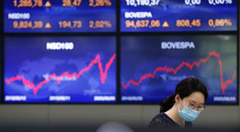 A currency trader watches monitors at the foreign exchange dealing room of the KEB Hana Bank headquarters in Seoul, South Korea, Monday, June 8, 2020. (AP Photo/Ahn Young-joon) A currency trader watches monitors at the foreign exchange dealing room of the KEB Hana Bank headquarters in Seoul, South Korea, Monday, June 8, 2020. (AP Photo/Ahn Young-joon)