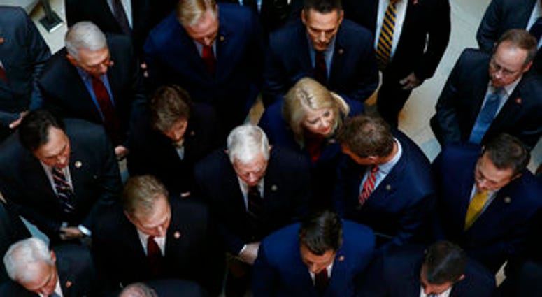 Rep. Debbie Lesko, R-Ariz., center, gathers with fellow House Republicans for a news conference after Deputy Assistant Secretary of Defense Laura Cooper arrived for a closed door meeting to testify. (AP Photo/Patrick Semansky)