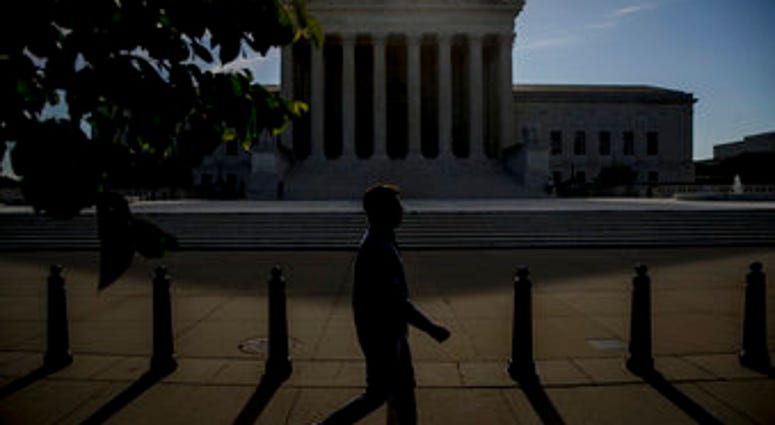 FILE - In this May 4, 2020, file a man walks past the Supreme Court in Washington. (AP Photo/Andrew Harnik, File) FILE - In this May 4, 2020, file a man walks past the Supreme Court in Washington. (AP Photo/Andrew Harnik, File)