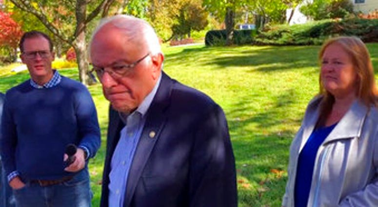 Democratic presidential candidate Sen. Bernie Sanders, I-Vt., speaks with reporters outside his home, Tuesday, Oct. 8, 2019, in Burlington, Vt. (AP Photo/Wilson Ring)