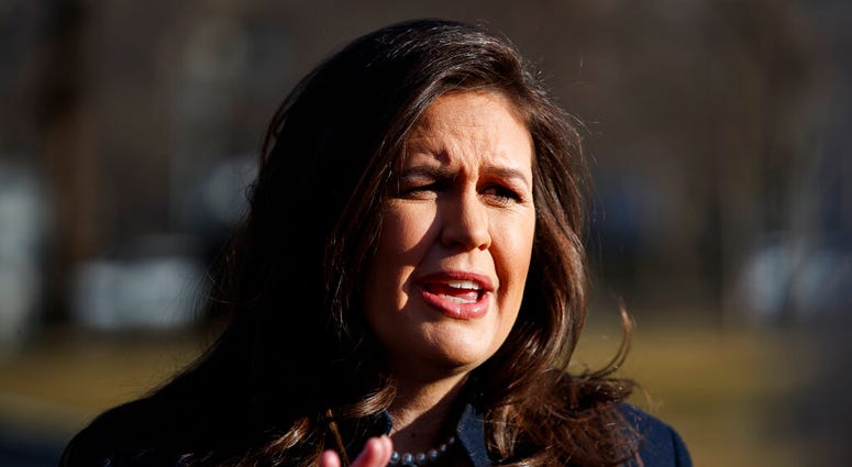 White House press secretary Sarah Sanders talks with reporters outside the White House, Wednesday, Feb. 13, 2019, in Washington. (AP Photo/ Evan Vucci)
