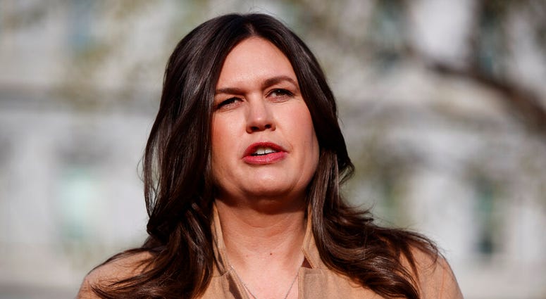 FILE - In this April 4, 2019, file photo, White House press secretary Sarah Sanders talks with reporters outside the White House in Washington. (AP Photo/Evan Vucci, File)