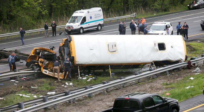 FILE - In this May 17, 2018, file photo, emergency personnel work at the scene of a school bus and dump truck collision on Interstate 80 in Mount Olive, N.J. Hudy Muldrow Sr., the school bus driver caused the fatal crash by crossing three lanes of traffic