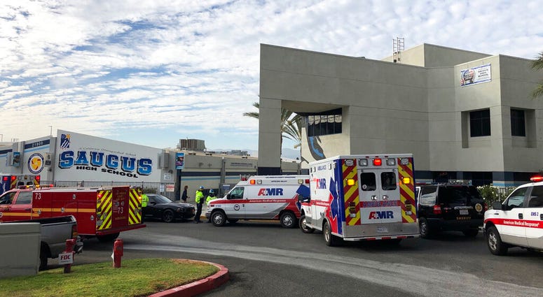 Ambulances are parked outside of Saugus High School after reports of a shooting on Thursday, Nov. 14, 2019 in Santa Clarita, Calif. (AP Photo/Marcio Jose Sanchez)