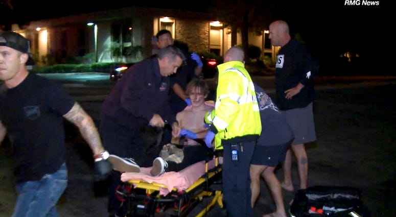 A victim is treated near the scene of a shooting, Wednesday evening, Nov. 7, 2018, in Thousand Oaks, Calif. (RMG News via AP)