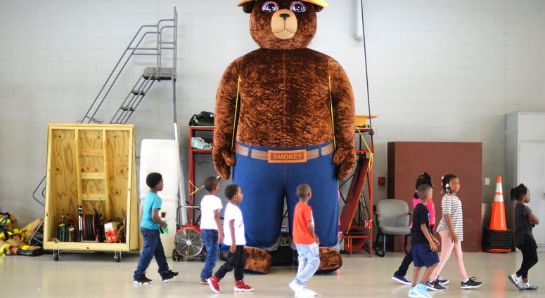 FILE - In this Wednesday, Oct. 11, 2017 file photo, a giant Smokey Bear statue greets children at the Fire Department Open House at Fire Station One in Kinston, N.C. (Janet S. Carter/Daily Free Press via AP)