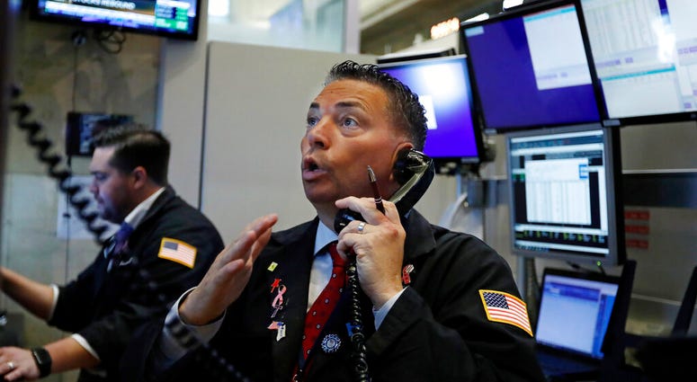 FILE - In this Aug. 6, 2019, file photo trader Jonathan Mueller works on the floor of the New York Stock Exchange. (AP Photo/Richard Drew, File)
