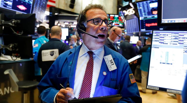 Trader Sal Suarino works on the floor of the New York Stock Exchange, Wednesday, Oct. 30, 2019. Stocks are slipping in early trading on Wall Street as traders hold back ahead of an announcement from the Federal Reserve. (AP Photo/Richard Drew)