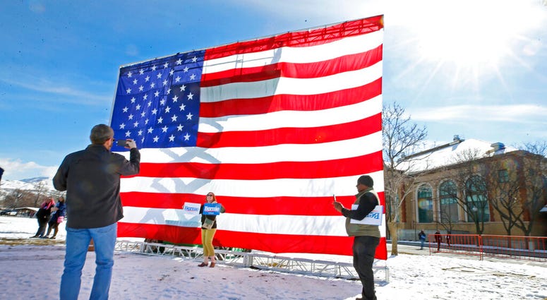 Supporters of Democratic presidential candidate Bernie Sanders take pictures in front of a large American flag before a rally Monday, March 2, 2020, in Salt Lake City. (AP Photo/George Frey) Supporters of Democratic presidential candidate Bernie Sanders take pictures in front of a large American flag before a rally Monday, March 2, 2020, in Salt Lake City. (AP Photo/George Frey)