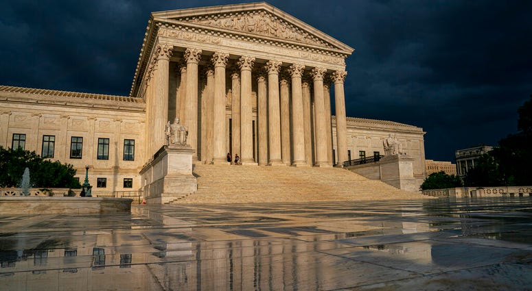 FILE - In this June 20, 2019 file photo, the Supreme Court is seen under stormy skies in Washington. (AP Photo/J. Scott Applewhite, File)