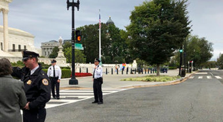 The streets outside the front of the Supreme Court are closed off for a suspicious package, Tuesday morning, Oct. 8, 2019 in Washington. (AP Photo/Mark Sherman)
