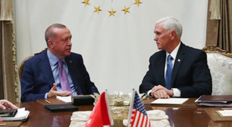 Turkey's President Recep Tayyip Erdogan, left, talks with U.S Vice President Mike Pence, during their meeting at the Presidential Palace in Ankara, Turkey. (Presidential Press Service via AP, Pool)