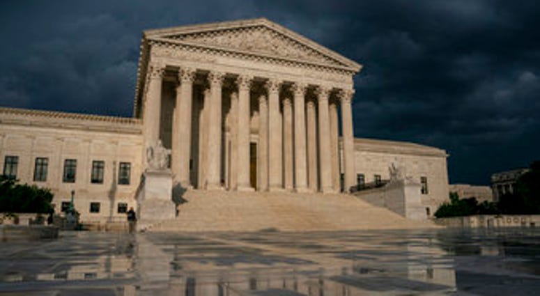 FILE - In this June 20, 2019 file photo, The Supreme Court is seen under stormy skies in Washington. The Supreme Court says it will hear President Donald Trump's pleas to keep his tax, bank and financial records private. (AP Photo/J. Scott Applewhite) FILE - In this June 20, 2019 file photo, The Supreme Court is seen under stormy skies in Washington. The Supreme Court says it will hear President Donald Trump's pleas to keep his tax, bank and financial records private. (AP Photo/J. Scott Applewhite)