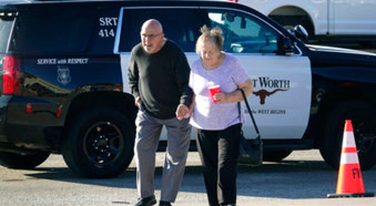 An elderly couple walks from West Freeway Church of Christ hours after a fatal shooting at the church, Sunday, Dec. 29, 2019, in White Settlement, Texas. The couple declined to comment to reporters. (AP Photo/David Kent) An elderly couple walks from West Freeway Church of Christ hours after a fatal shooting at the church, Sunday, Dec. 29, 2019, in White Settlement, Texas. The couple declined to comment to reporters. (AP Photo/David Kent)