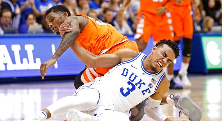 Duke's Tre Jones (3) tangles with Syracuse's Frank Howard during the first half of an NCAA college basketball game in Durham, N.C., Monday, Jan. 14, 2019. Jones was injured on the play and left the court. No. 1-for-now Duke will have to figure out how to