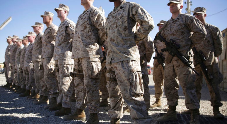 FILE - In this Jan. 15, 2018 file photo, U.S. Marines stand guard during the change of command ceremony at Task Force Southwest military field in Afghanistan. (AP Photo/Massoud Hossaini, File)
