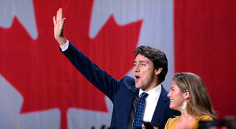 Liberal leader Justin Trudeau and wife Sophie Gregoire Trudeau wave as they go on stage at Liberal election headquarters in Montreal, Monday, Oct. 21, 2019. (Ryan Remiorz/The Canadian Press via AP)