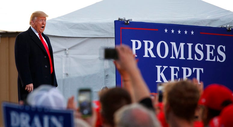 President Donald Trump calls out as he arrives at a campaign rally at Minuteman Aviation Hangar, Thursday, Oct. 18, 2018, in Missoula, Mont. (AP Photo/Carolyn Kaster)