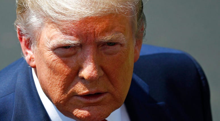 President Donald Trump speaks with reporters before departing on Marine One on the South Lawn of the White House, Wednesday, Aug. 21, 2019, in Washington. Trump is headed to Kentucky. (AP Photo/Patrick Semansky)