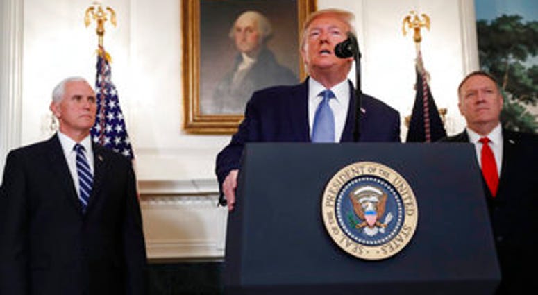 President Donald Trump, accompanied by Vice President Mike Pence, left, and Secretary of State Mike Pompeo, speaks Wednesday, Oct. 23, 2019, in the Diplomatic Room of the White House in Washington. (AP Photo/Jacquelyn Martin)