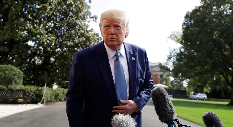 President Donald Trump talks to reporters on the South Lawn of the White House, Friday, Oct. 4, 2019, in Washington. (AP Photo/Evan Vucci)