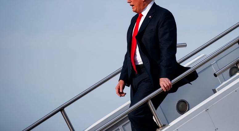 President Donald Trump walks off Air Force One after arriving at Evansville Regional Airport, Thursday, Aug. 30, 2018, in Evansville, Ind. (AP Photo/Evan Vucci)