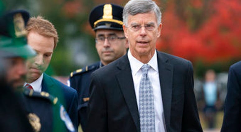 Ambassador William Taylor, is escorted by U.S. Capitol Police as he arrives to testify before House committees as part of the Democrats' impeachment investigation, at the Capitol, Tuesday, Oct. 22, 2019. (AP Photo/J. Scott Applewhite)