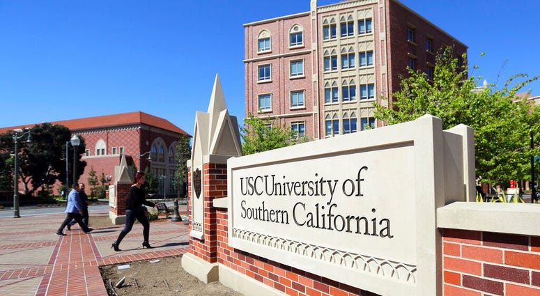 FILE - This Tuesday, March 12, 2019 file photo shows the University Village area of the University of Southern California in Los Angeles. (AP Photo/Reed Saxon,File)