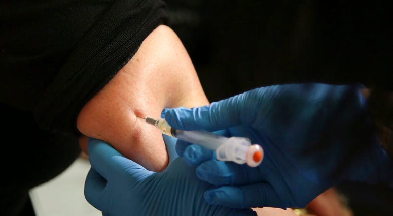 FILE - In this March 27, 2019, file photo, a woman receives a measles, mumps and rubella vaccine. Measles cases in the U.S. this year have climbed to the highest level in 25 years. (AP Photo/Seth Wenig, File)