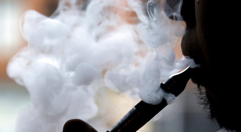 FILE - In this April 23, 2014 file photo, a man smokes an electronic cigarette. (AP Photo/Nam Y. Huh, File)