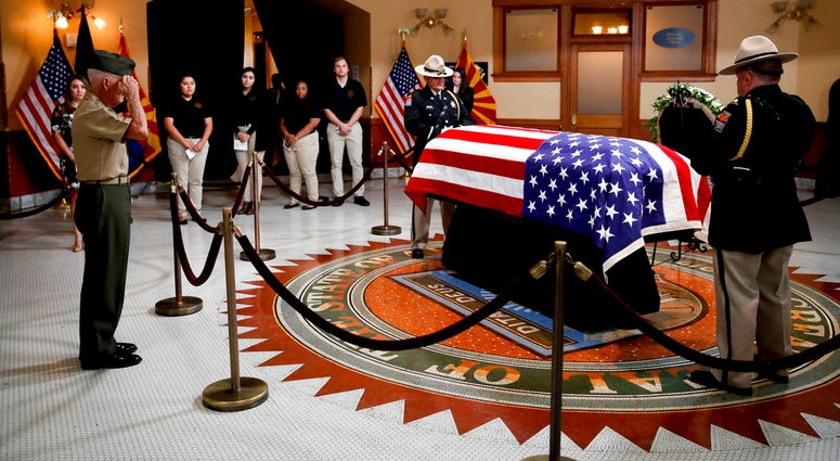 Former U.S. Marine Jose Cordero Torres, 82, a Vietnam War veteran salutes near the casket during a memorial service for Sen. John McCain, R-Ariz. at the Arizona Capitol on Wednesday, Aug. 29, 2018, in Phoenix. (AP Photo/Jae C. Hong, Pool)