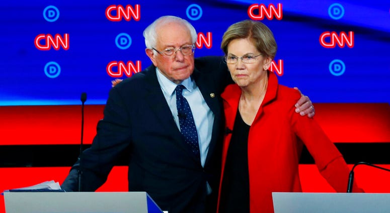 FILE - In this July 30, 2019 file photo, Sen. Bernie Sanders, I-Vt., and Sen. Elizabeth Warren, D-Mass., embrace after the first of two Democratic presidential primary debates hosted by CNN in the Fox Theatre in Detroit. (AP Photo/Paul Sancya)