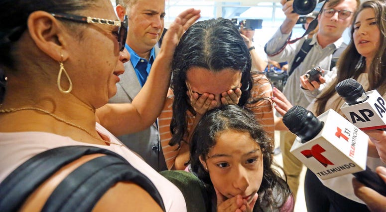 Alejandra Juarez,38, left, says goodbye to her children, Pamela and Estela at the Orlando International Airport on Friday, Aug. 3, 2018 in Orlando, Fla. Juarez, the wife of a former Marine is preparing to self-deport to Mexico in a move that would split u