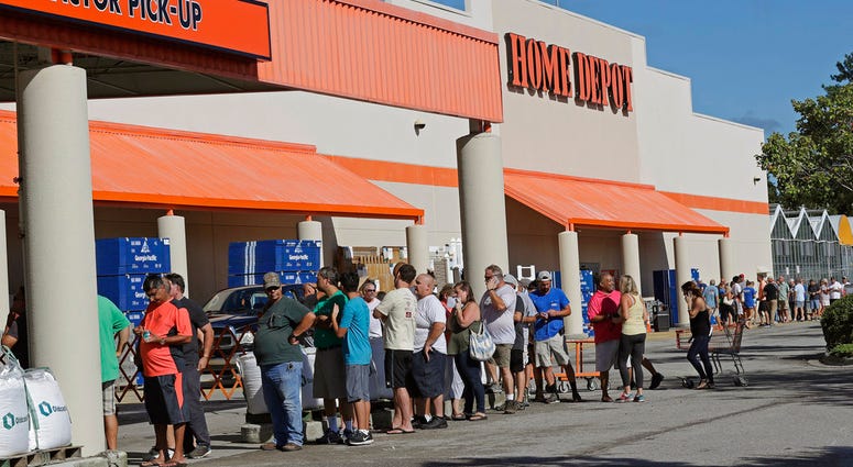 People line up outside a Home Depot for a new supply of generators and plywood in advance of Hurricane Florence in Wilmington, N.C., Wednesday, Sept. 12, 2018. Florence exploded into a potentially catastrophic hurricane Monday as it closed in on North and