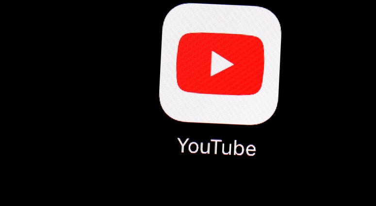 FILE - This March 20, 2018 file photo shows the YouTube app on an iPad in Baltimore. YouTube is updating its hate speech policies to prohibit videos with white supremacist and neo-Nazi content. (AP Photo/Patrick Semansky, File)