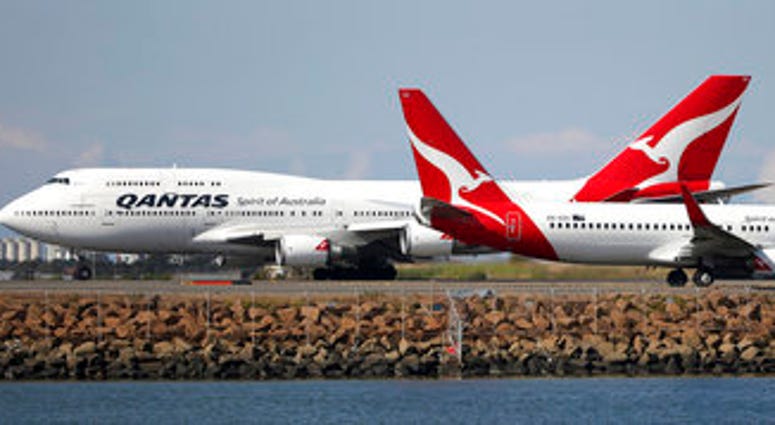 FILE - In this Aug. 20, 2015 file photo, two Qantas planes taxi on the runway at Sydney Airport in Sydney, Australia. Some Asian airlines have rerouted flights to the Middle East to avoid Iranian airspace. (AP Photo/Rick Rycroft, File) FILE - In this Aug. 20, 2015 file photo, two Qantas planes taxi on the runway at Sydney Airport in Sydney, Australia. Some Asian airlines have rerouted flights to the Middle East to avoid Iranian airspace. (AP Photo/Rick Rycroft, File)