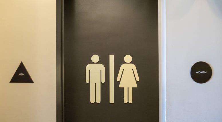 Men and women restroom entrance, equal distance signs in doors (Dreamstime)
