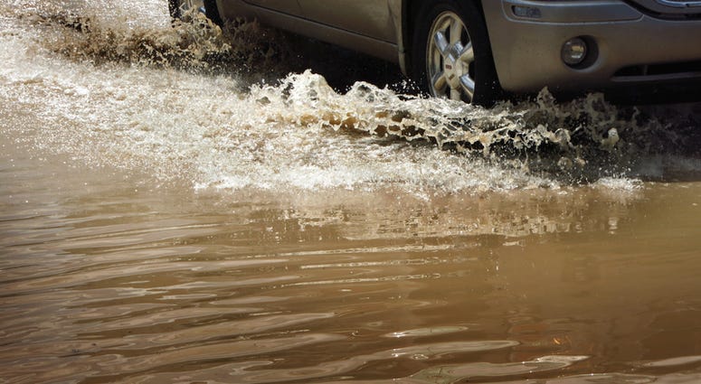 Car in Flood waters (Dreamstime)