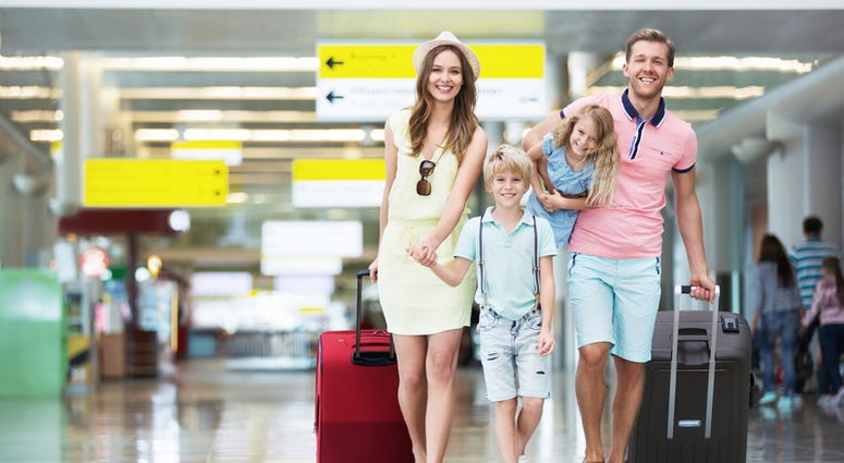 Happy family with suitcases in the airport. © Denis Raev | Dreamstime.com Happy family with suitcases in the airport. © Denis Raev | Dreamstime.com