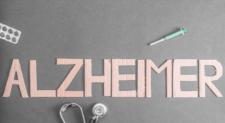 A stethoscope, pills and a disposable syringe on a dark background with the word Alzheimer made out of cardboard. (Dreamstime) A stethoscope, pills and a disposable syringe on a dark background with the word Alzheimer made out of cardboard. (Dreamstime)