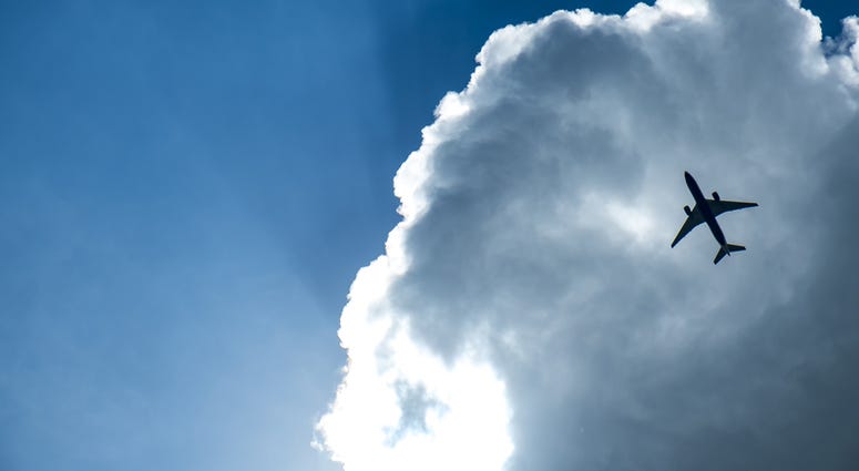 Passenger airplane in the clouds and sunray.(Dreamstime) Passenger airplane in the clouds and sunray.(Dreamstime)