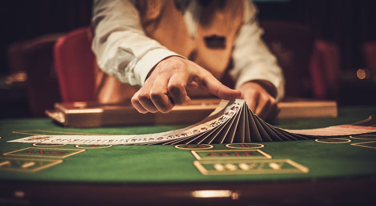 Croupier behind gambling table in a casino. (Dreamstime) Croupier behind gambling table in a casino. (Dreamstime)