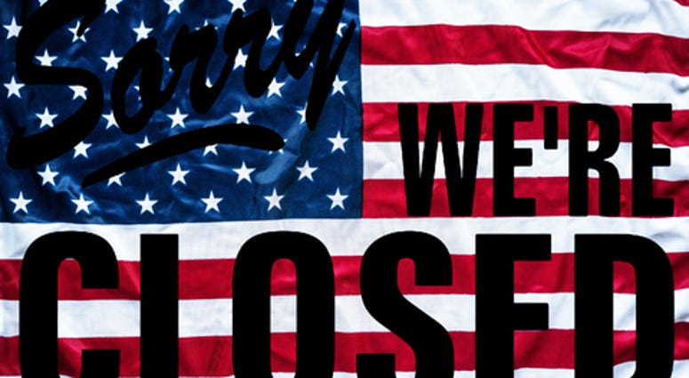 Government shutdown represented by a sorry we`re closed sign outline with american flag background
