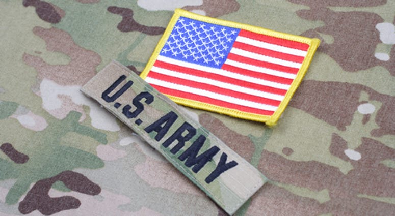 US ARMY branch tape with flag patch on camouflage uniform background