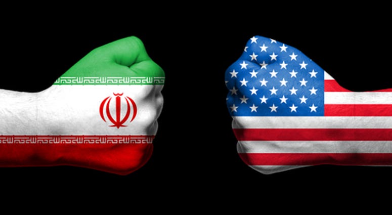 Flags of USA and Iran painted on two clenched fists facing each other on black background/Tensed relationship between USA and Iran