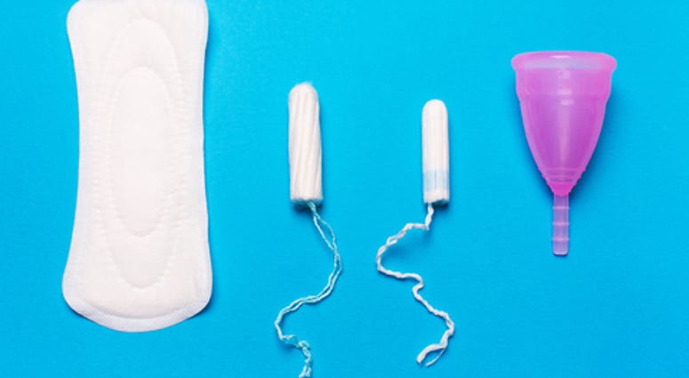 Pad, menstrual cup, tampon on a blue background
