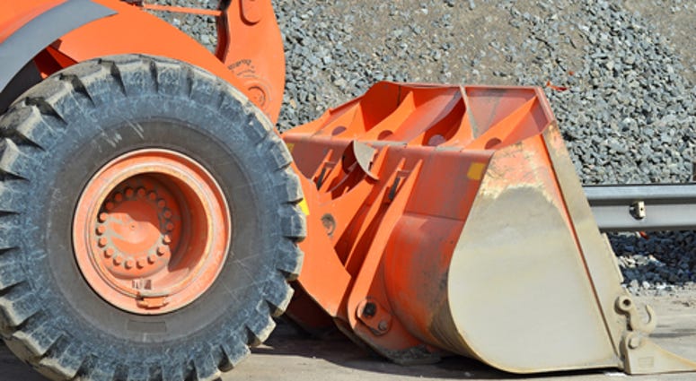 Orange bulldozer on bridge road construction site